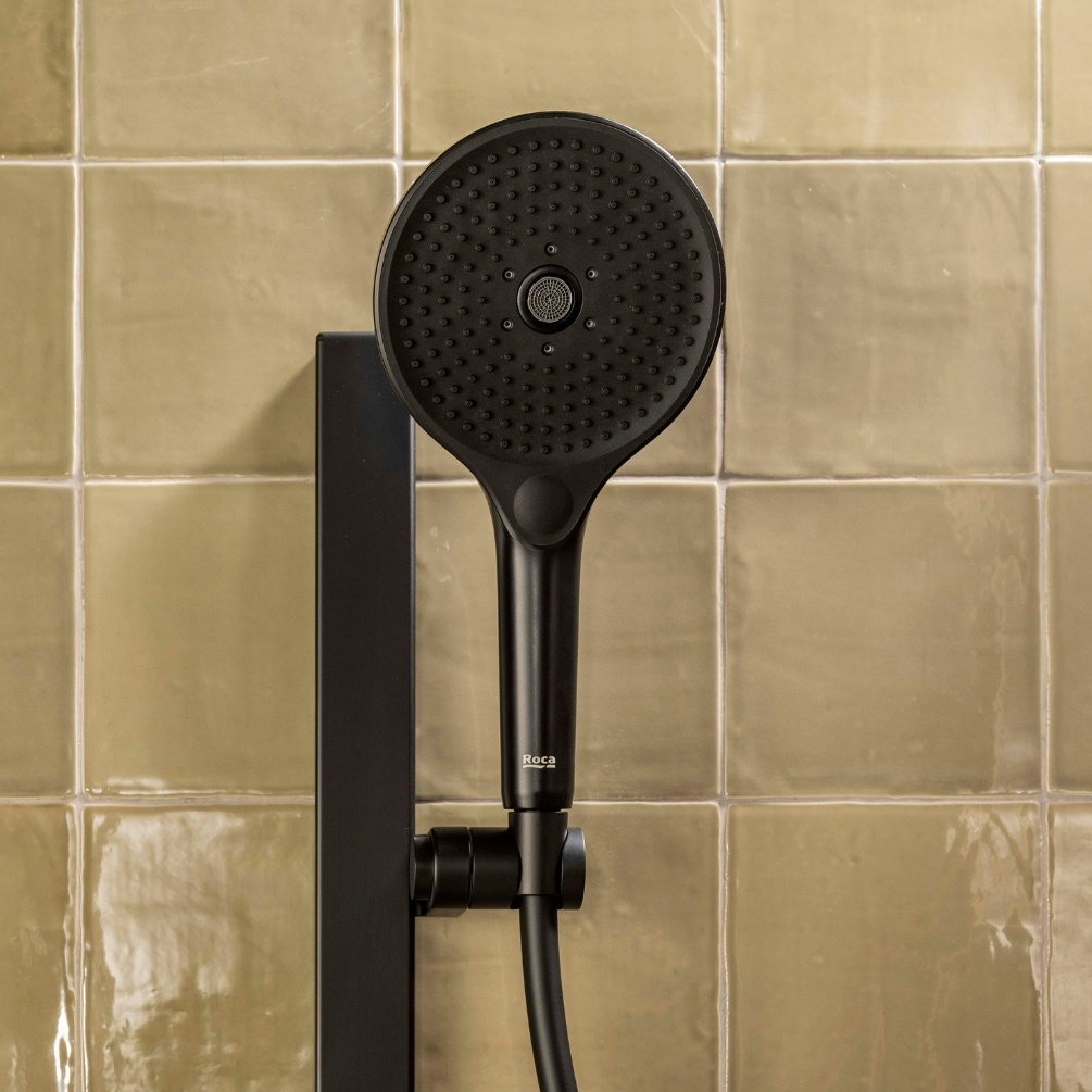 Lifestyle image of the Roca Plenum Matt Black 3 Function Round Handset Shower
